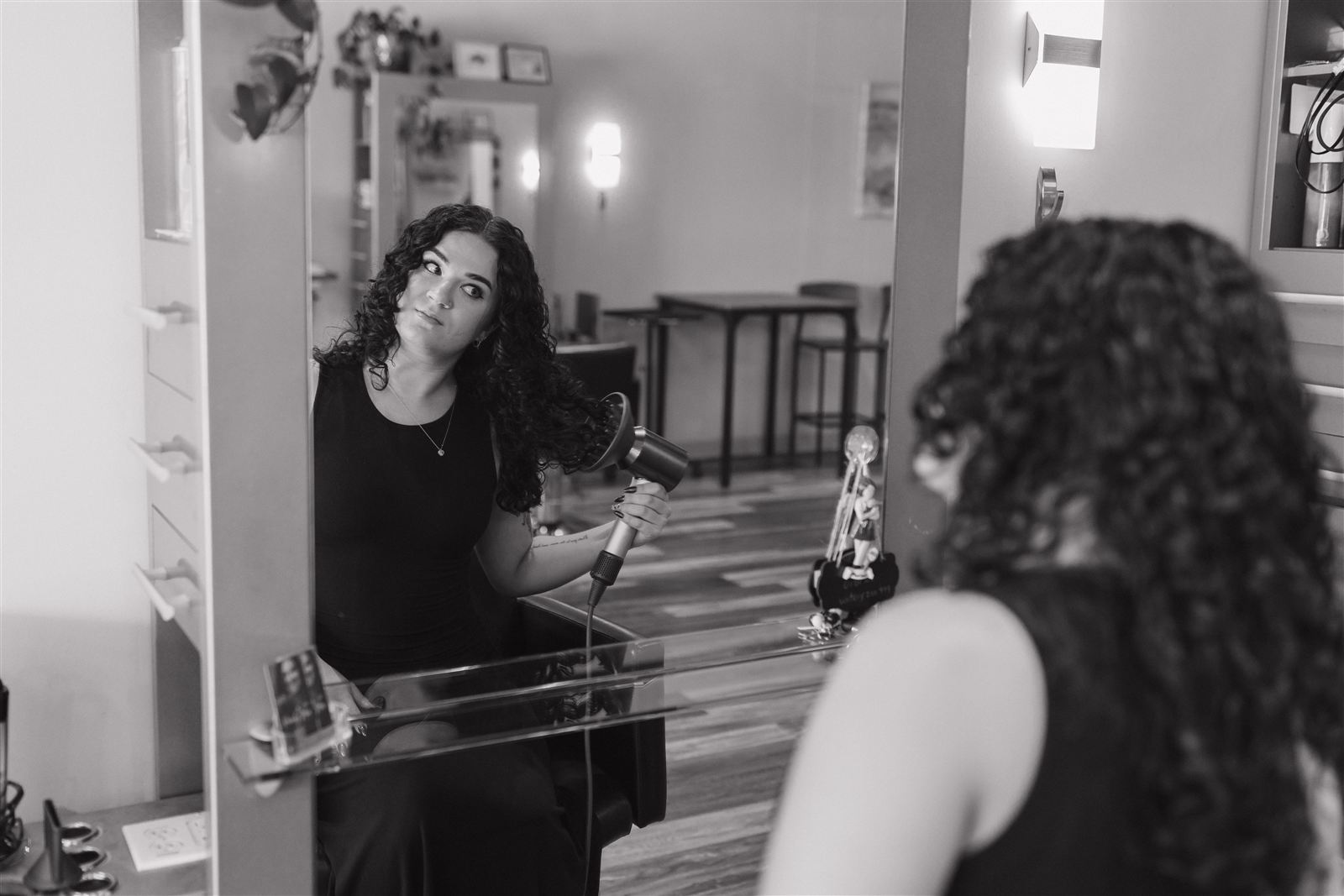 Stylist Marianna styling curly hair at Duality Salon